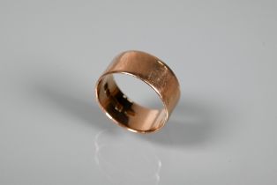 A 9ct rose gold wide wedding band, approx 8mm wide, approx 5.9g, size U