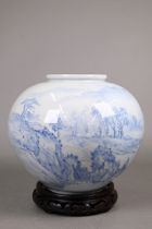 A 20th century Korean blue and white globular vase painted in underglaze blue with a mountainous