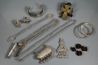 A collection of white metal Omani jewellery including bangles, chains, pendants, glass-set Coptic