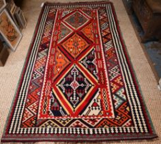 A contemporary South West Persian Qashqai Kelim with repeating stylized lozenges in multi-colours,