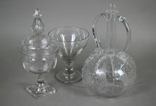 An antique Dutch glass decanter with twin loop handles, applied ribbon-work and etched vine and bird