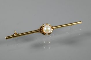 Mikimoto - A yellow metal bar brooch with central pearl, stamped Mikimoto Tokyo KI4, 6.5 cm long,