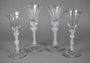 A pair of drinking glasses with vine-etched bell bowls on opaque twist baluster stems, 17.8 cm, to/w