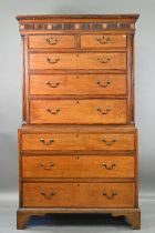 A George III cross-banded oak chest on chest, the moulded cornice with inlaid boxwood roundels, over