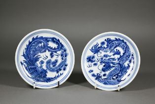 A pair of Chinese blue and white circular stands or dishes, painted in underglaze blue with a dragon