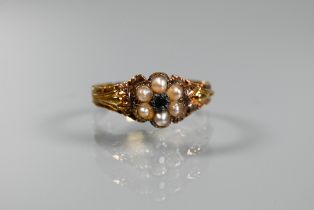 A Victorian cluster ring, the central cluster set with six small half pearls surrounding a single