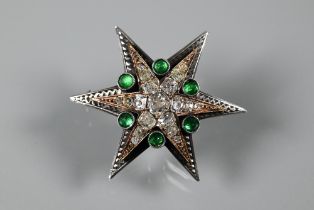 A Victorian diamond and emerald star-shaped brooch, the six point star gold set with mixed cut