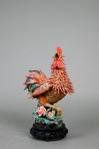 A late 19th or early 20th century Chinese (possibly Shiwan) polychrome pottery rooster standing on