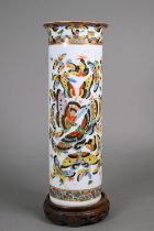 A 19th century Chinese cylindrical sleeve vase painted in bright polychrome enamels with a