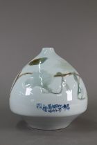 A modern Chinese lotus bud form vase, pale celadon glaze with low-relief magnolia branches,