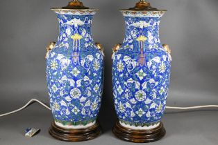 A pair of 19th century Chinese blue ground baluster vases painted with continuous composite floral