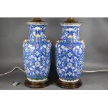 A pair of 19th century Chinese blue ground baluster vases painted with continuous composite floral