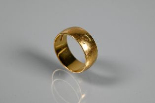 An 18ct yellow gold wide D-shaped wedding band, approx 7mm wide, size O, 7.1g