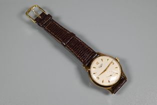 A vintage Longines gents 9ct watch, the champagne dial with subsidiary seconds, with leather strap