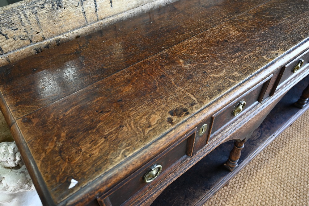 An antique oak low dresser with three double moulded front drawers over a triple arched apron, - Image 4 of 23