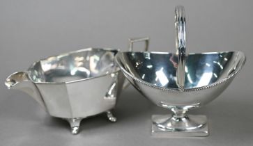 A late Victorian silver Adam Revival bonbon basket of navette form with swing loop handle, with