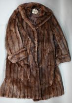 A vintage brown fur coat, below knee length, retailed by Dickens & Jones