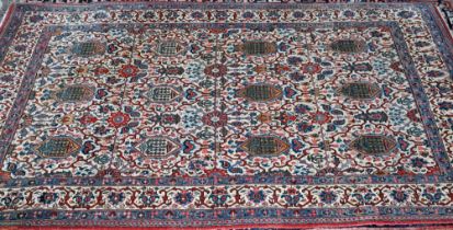 An antique Persian Kashan rug, the repeating design of floral vines on camel ground, 208 cm x 138 cm