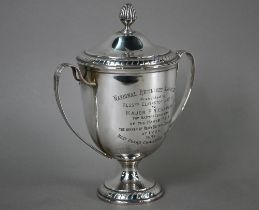 An Edwardian silver two-handled trophy cup and cover on stemmed foot, Elkington & Co, Birmingham