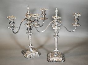 A pair of ep three branch candelabra in the rococo manner