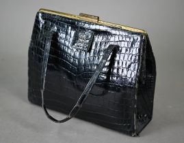 Asprey - A vintage black crocodile handbag, circa early 1960s, with twin handles, gold tone hardware