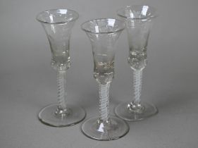 Three 18th Century cordial glasses, the waisted bell bowls wheel-etched with fruiting vine