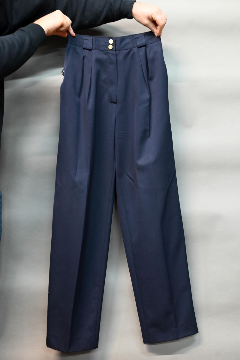Chanel - A pair of navy trousers, with pleated front and gilt metal button detailing, fully lined,