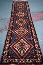 A contemporary North West Persian Rudbar runner, the mid-blue lozenge pole design on camel ground,