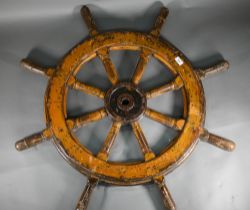 An antique iron and teak ship's wheel, 99 cm diam, well patinated, painted/varnished