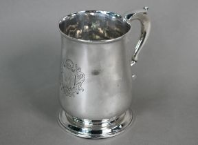 A George III silver baluster pint mug with scroll handle and moulded flared foot, maker -F (rubbed),