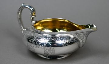 A Victorian silver milk jug of compressed form with engraved decoration and scroll handle, Garrards,