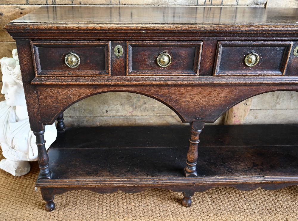 An antique oak low dresser with three double moulded front drawers over a triple arched apron, - Image 3 of 23