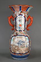 A large 19th century Japanese Imari vase with scrolling foliate handles, with six character '