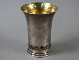 Frances Loyen:  a silver beaker with flared rim and gilt interior, the base pierced and decorated