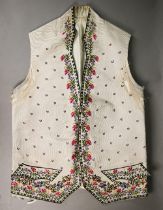 An 18th century European gentleman's cream silk waistcoat, finely embroidered overall with sprigs of