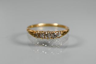 An antique five stone diamond ring, the old cut graduated diamonds in 18ct yellow gold shank,
