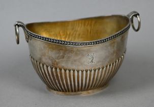 A Victorian silver half-reeded sugar basin of elliptical form with ring handles, Frederick