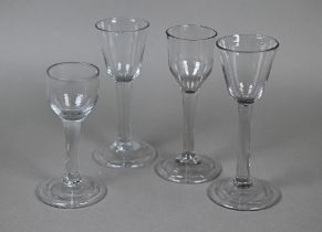 Four cordial glasses - one with ogee bowl, two with round funnel bowls and another with cup bowl -