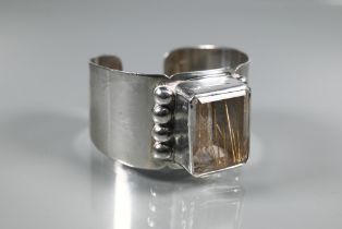 Navajo interest - A Sam Piaso white metal cuff bracelet set with large rectangular rutilated quartz,