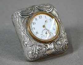 An Edwardian travel clock with Art Nouveau embossed and chased silver front to the strut-case,