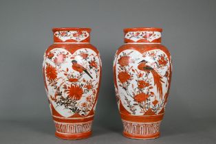 A pair of 19th century Japanese Kutani vases, Meiji period (1868-1912) painted with panels of