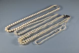 Two pearl necklaces, one graduated cultured pearls double knotted throughout onto diamond clasp