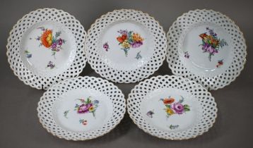Five Meissen cabinet plates, painted with floral sprays, within basket-weave lattice rims with