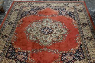 An old Persian Indo Persian Saruk carpet, the deep pink ground centred by a floral medallion, 390 cm