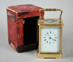 A gilt-cased two train 8-day carriage alarm clock with white enamelled and Roman numeral dial, 13.