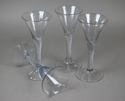Four trumpet-bowl drinking glasses on air twist stems with conical foot, 17.5 cm high approx (4)