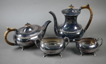 A heavy quality silver four-piece tea/coffee service with simulated ivory handles and chased pad