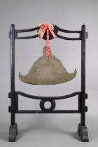 A 19th century Burmese bell-metal spinning gong, kyeezee, suspended from hardwood stand, 56 cm high