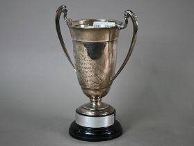 A silver two-handled trophy cup on stemmed foot, maker CE, London 1938, 10.9oz, 21cm high o/a, on