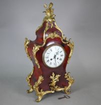 An antique French two train mantel clock in faux red tortoiseshell and ormolu case
